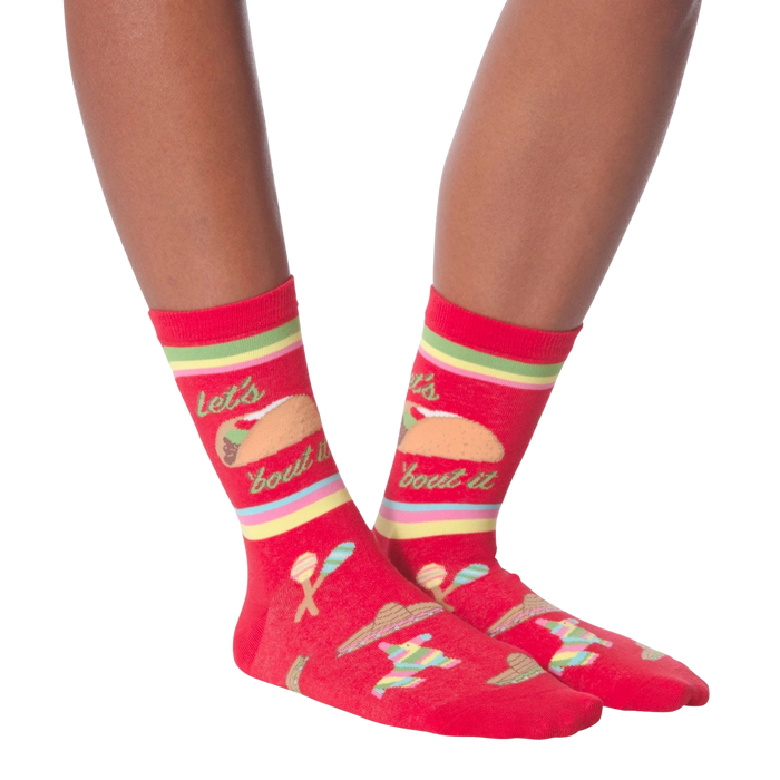 Pair of 'Let's Taco Bout It' socks on a black background, showcasing the full design.