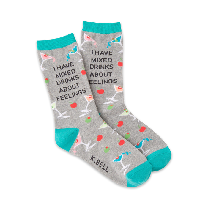 Gray crew socks with teal cuffs, featuring martini glasses, olives, cherries, and the text 'I HAVE MIXED DRINKS ABOUT FEELINGS'.
