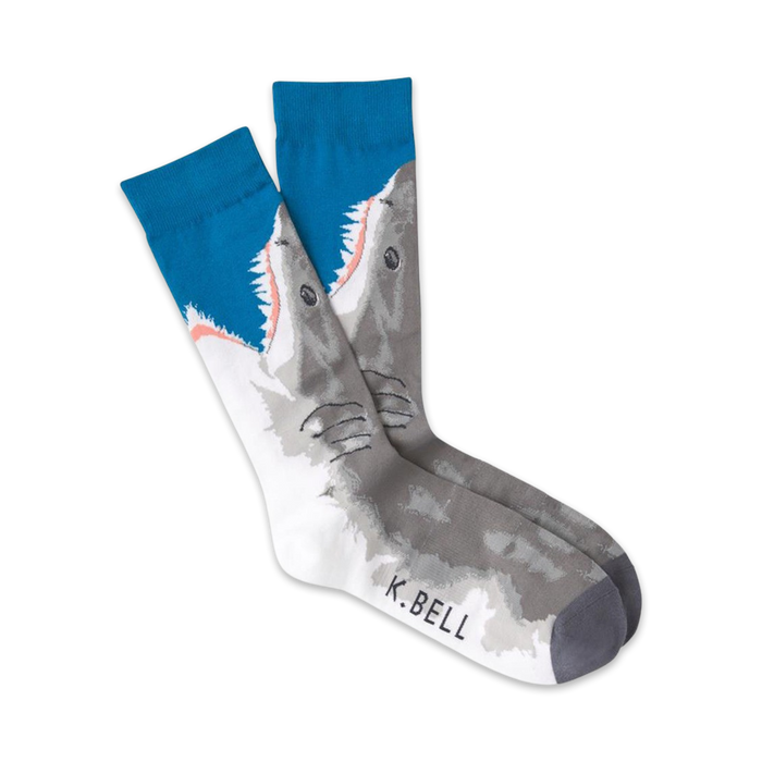 Pair of crew socks featuring a great white shark design. The socks are mainly gray and white with teal blue at the top.  }}