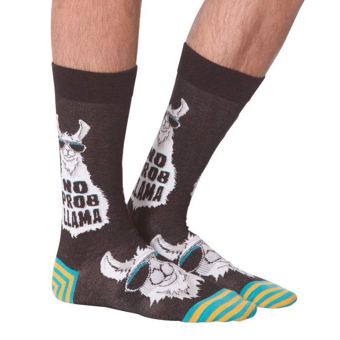 A pair of brown socks with a llama wearing sunglasses and the words 