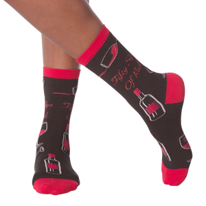 Lifestyle shot of model's legs wearing the 'Fifty Sips of Red' socks, showing the socks on feet.