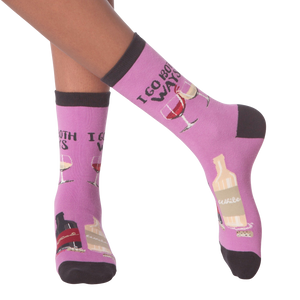 Lifestyle shot: 'I Go Both Ways' socks on a person's legs against a black background.