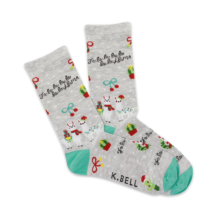 gray women's crew socks depicting green cacti, red ornaments, and yellow and white snowflakes. a green cuff and toe is included. 