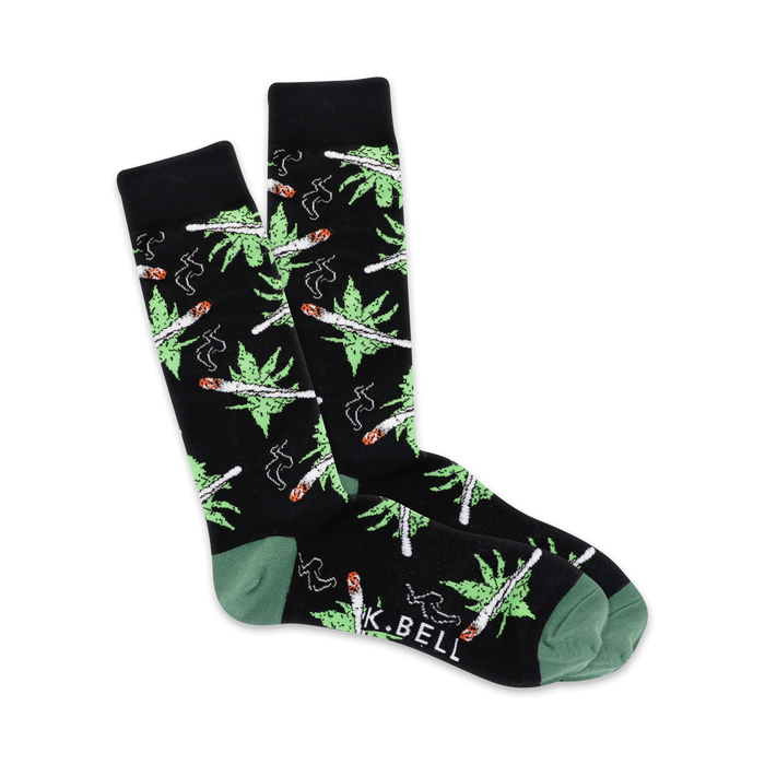 A pair of black crew socks with a whimsical design of green cannabis leaves and joints. Green cuffs add a pop of color. }}