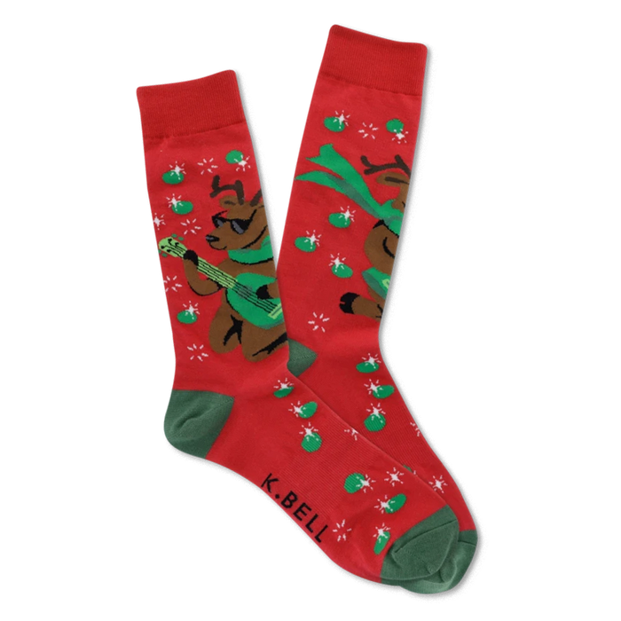 Pair of red crew socks with green cuffs, heels, and toes, featuring brown reindeer in sunglasses playing green guitars with starbursts and green ovals. }}