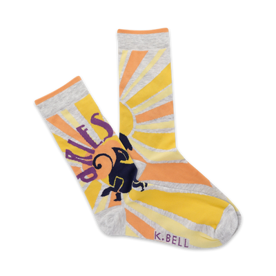 Crew socks in yellow, orange, and grey. A sunburst design surrounds an illustrated ram, with 'Aries' partially visible.
