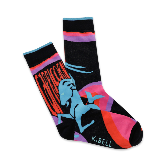 A pair of crew socks showcasing a stylized Capricorn in teal, against a black background with orange and pink accents. }}