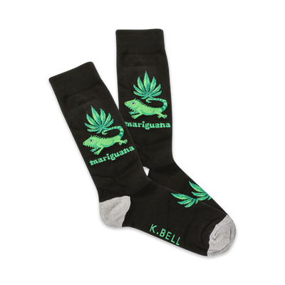 A pair of black crew socks with a fun design.  Green iguanas and marijuana leaves are featured on a black background. The socks have a grey heel and toe.