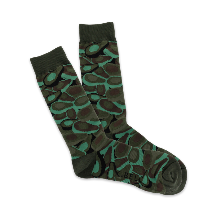 men's crew socks with an all-over pattern of avocado halves in various shades of green on an olive drab background.   }}