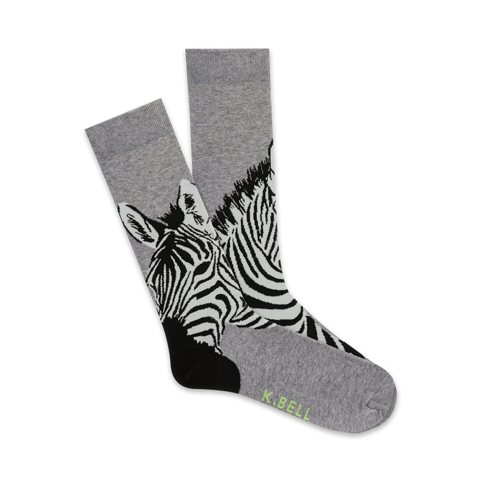Pair of grey crew socks with a black and white zebra print. The zebras' faces are prominently featured at the bottom of the socks. }}