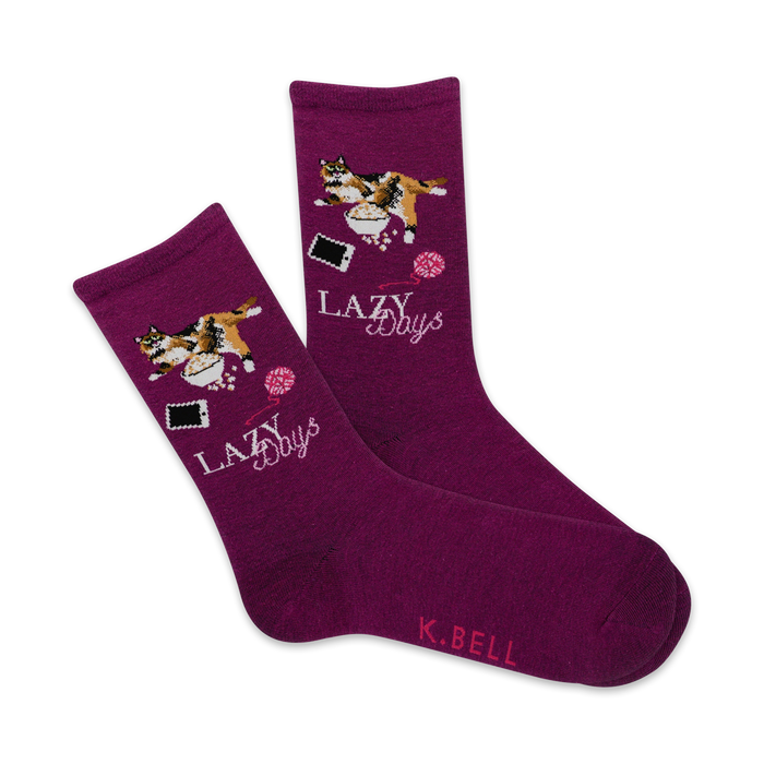 purple crew socks for women with a pattern of a lazy cat wearing a pink bow tie, resting on a pink pillow with yarn and a pink telephone nearby.    }}