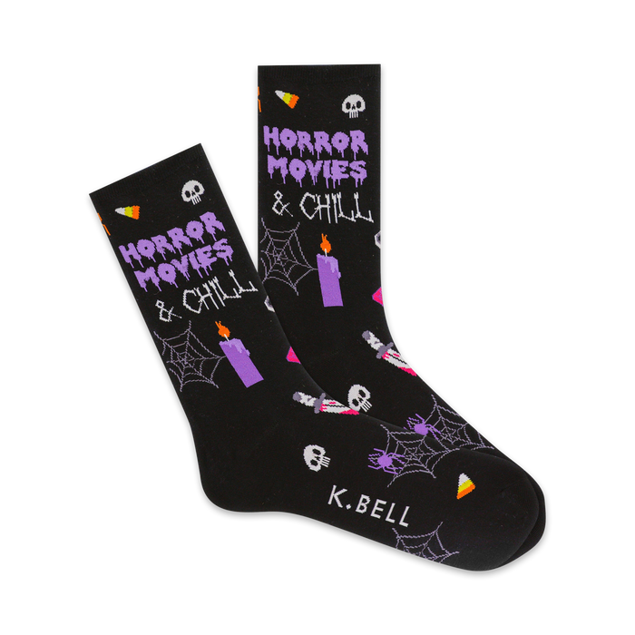 Black crew socks with a Halloween theme.  Purple text says 'Horror Movies & Chill'. Design includes skulls, spiders, candles, and candy corn. }}