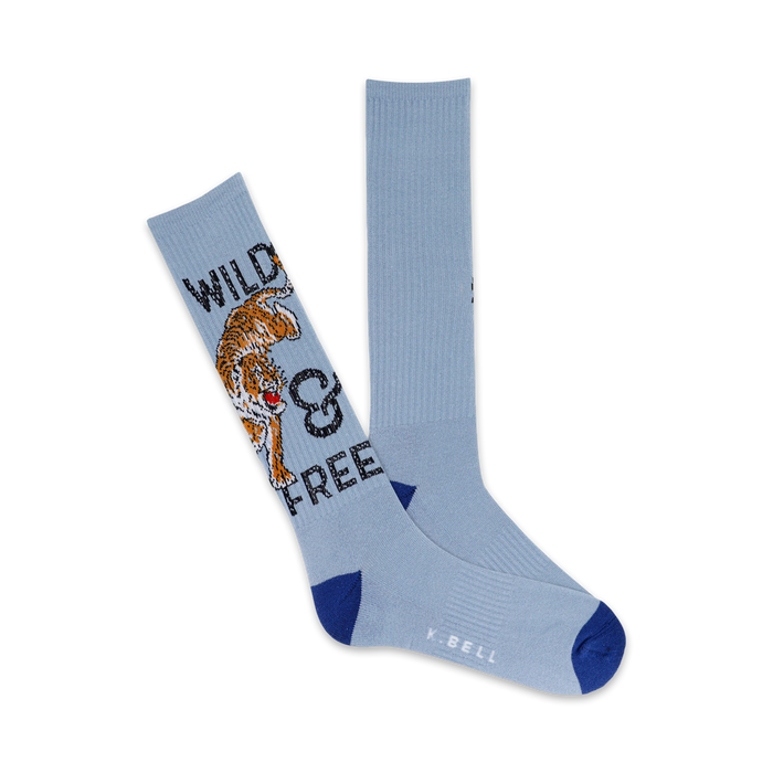 A pair of light blue crew socks with a graphic design of an orange tiger and the text 'Wild & Free'. }}