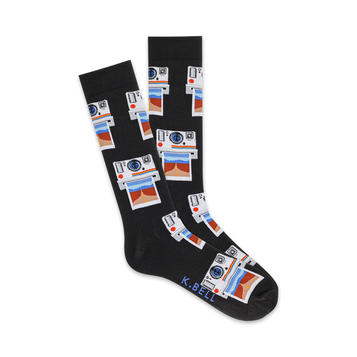 Pair of black crew socks with a repeating pattern of vintage cameras and photos in red, blue, and white. The brand name K.BELL is on the sole. }}