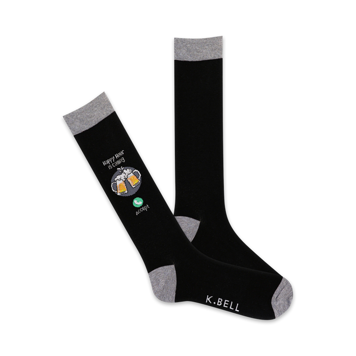 A pair of black crew socks with a grey cuff. One sock shows a design of two beer steins and the words 'Happy Hour is Calling' with an 'accept' button. }}