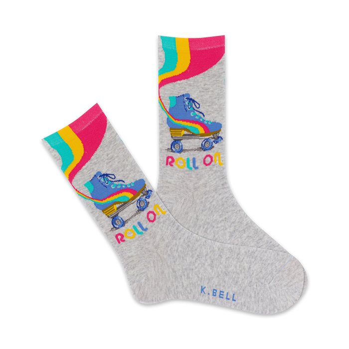 crew socks with blue roller skates with yellow wheels and pink laces. the word 