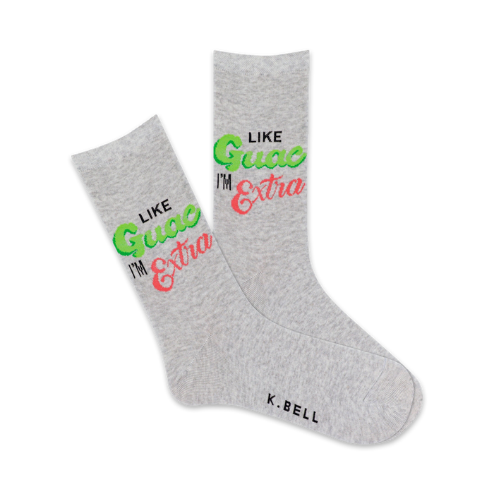 Pair of grey crew socks with the phrase 'Like Guac I'm Extra' in lime green and pink lettering. Fun and vibrant design. }}