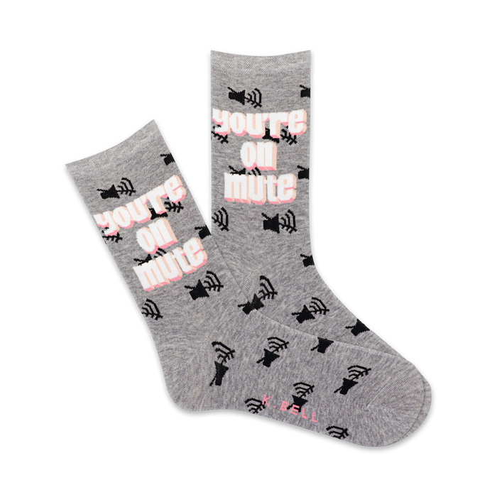 A pair of grey crew socks featuring a repeated pattern of black mute icons and the phrase 'You're On Mute' in pink. }}