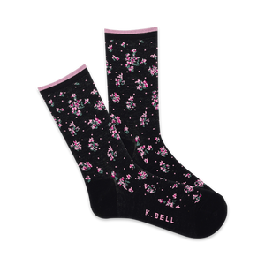 Pair of black crew socks with a delicate pink and green floral pattern.  Features a subtle pink cuff and 'K.BELL' logo.