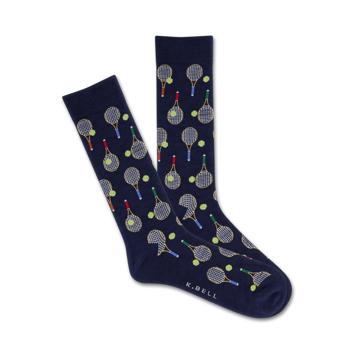 A pair of navy blue crew socks with a fun tennis theme. The socks are covered in yellow tennis rackets and green tennis balls. }}