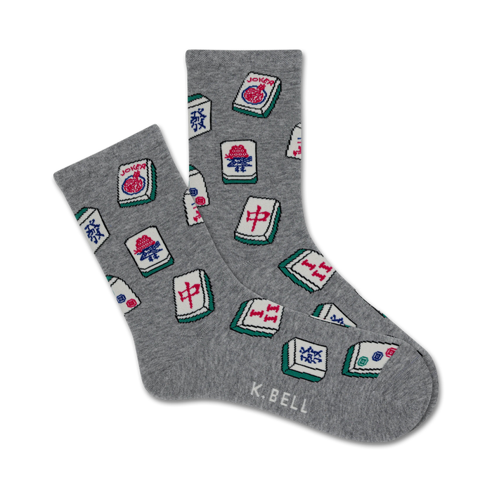 A pair of grey crew socks with a scattered pattern of colorful Mahjong tiles. The tiles feature red, green, and blue details on a white background. }}