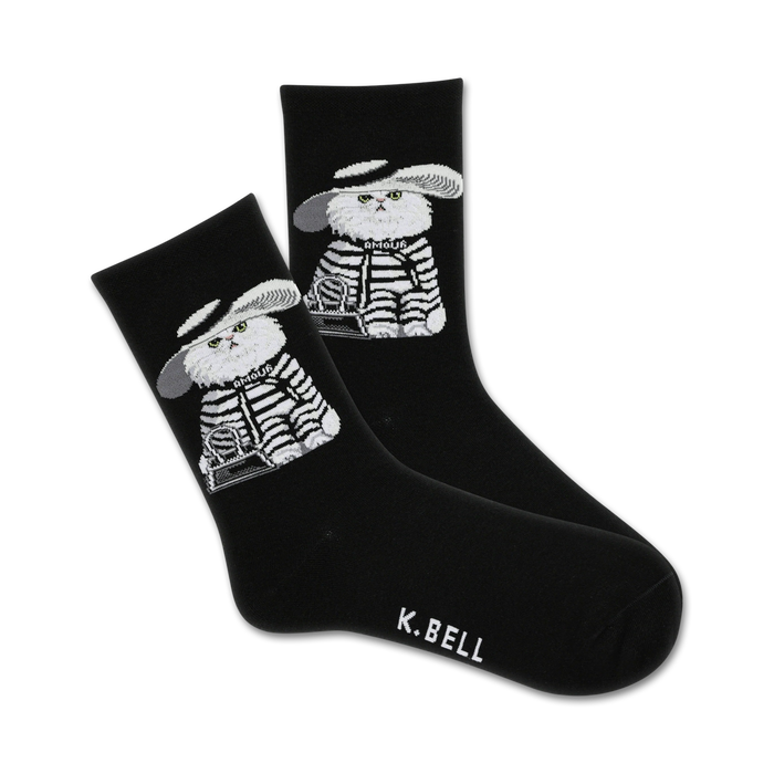 Pair of black crew socks with a graphic design of a white cat wearing a hat and striped outfit. The cat holds a small bag. }}
