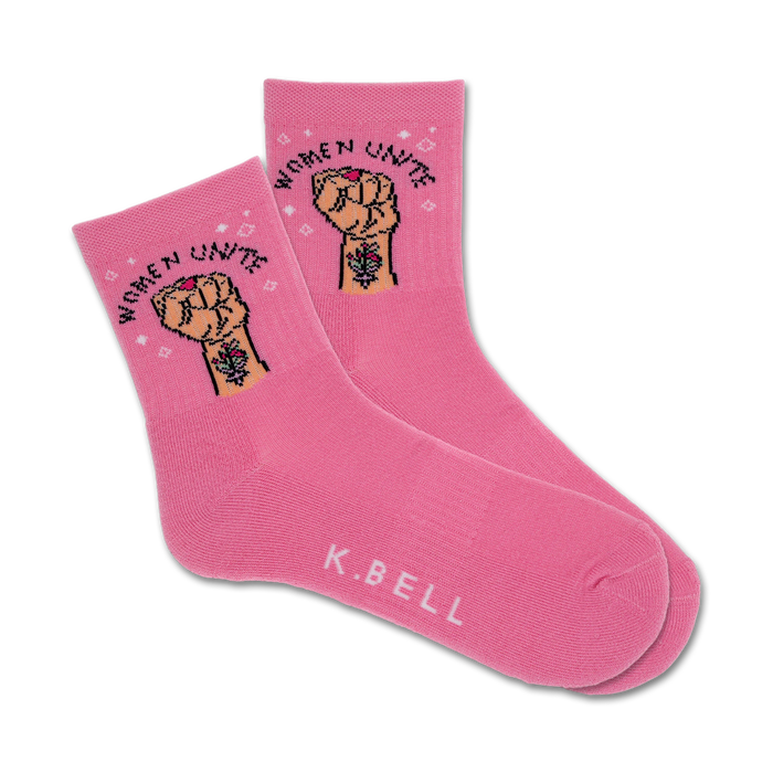 Pair of pink crew socks with a graphic of a raised fist and the text 'Women Unite'.