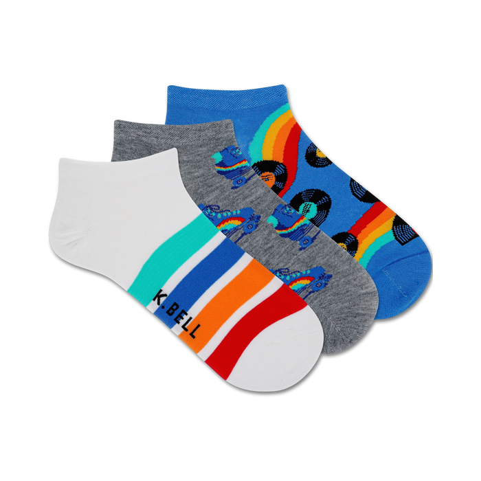 Three pairs of ankle socks. One white with colorful stripes, one gray with roller skates and records, one blue with rainbows and records. }}