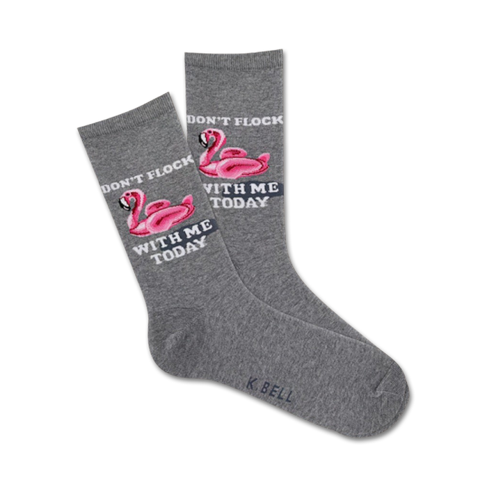 Pair of grey crew socks with pink flamingo inflatable pool toys and the text