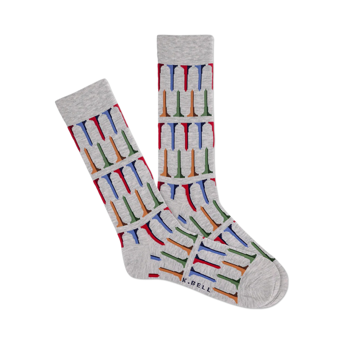 Pair of heather gray crew socks with a repeating pattern of multicolored golf tees. The socks are shown laid flat and feature a subtle 'K.BELL' brand marking. }}