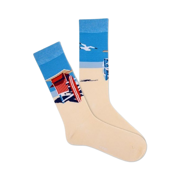 Pair of cream crew socks showcasing a beach scene: blue ocean, lifeguard stand, and a flying seagull.  }}