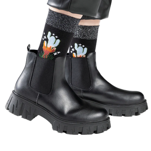 Lifestyle shot showing the socks worn with black ankle boots.