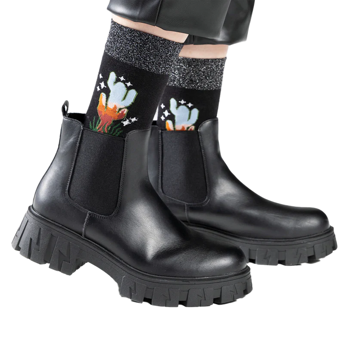 Lifestyle shot showing the socks worn with black ankle boots.