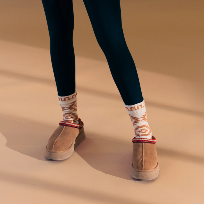 Lifestyle photo showing the socks paired with suede clogs.