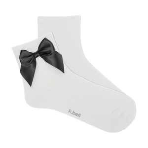 Pair of white ribbed ankle socks with a black satin bow.  The socks are shown against a black background.