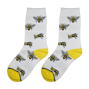 Close-up view of a pair of white socks with yellow bee illustrations.