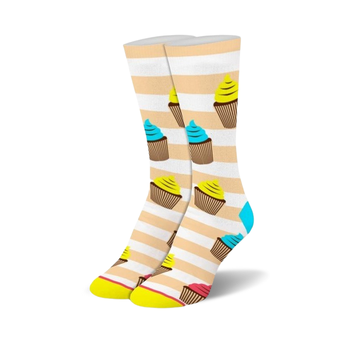 Cream and white striped crew socks adorned with colorful cupcake illustrations in yellow, blue, and pink. }}