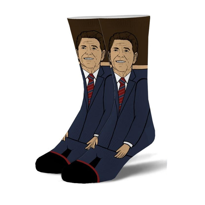 A pair of crew socks depicting Ronald Reagan in a navy suit and red tie.  The background is brown, and the design is illustrated. }}