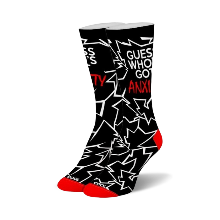 Pair of black crew socks with a white and red graphic design. The socks feature jagged lines and the text 'Guess who's got anxiety?' }}
