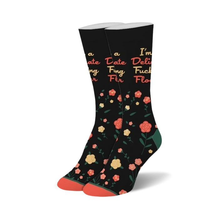 Pair of black crew socks with a scattered coral flower pattern and a playful text overlay.  The text says 'I'm a Delicate Flower'. }}