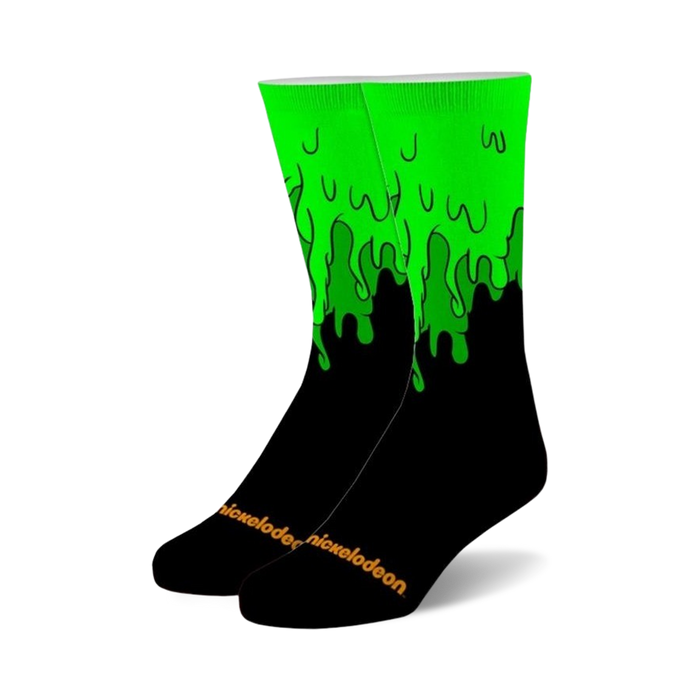 Pair of black crew socks with bright green slime dripping down the sides. Nickelodeon logo is subtly displayed on the bottom. }}