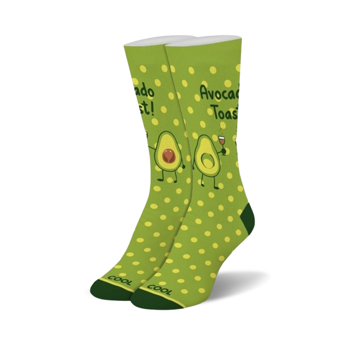 Pair of crew socks in green with yellow polka dots. Features illustrations of avocados making a toast, with one holding a glass of wine. }}