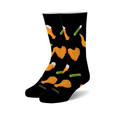 Pair of black crew socks with a fun pattern of orange buffalo wings and green celery stalks.