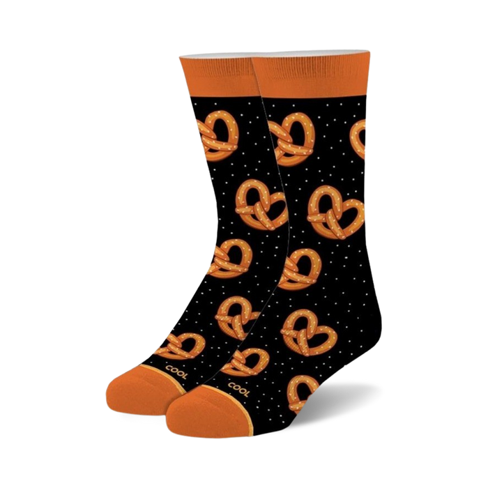 Pair of black crew socks with an all-over pattern of orange pretzels and white dots. Orange cuffs. }}