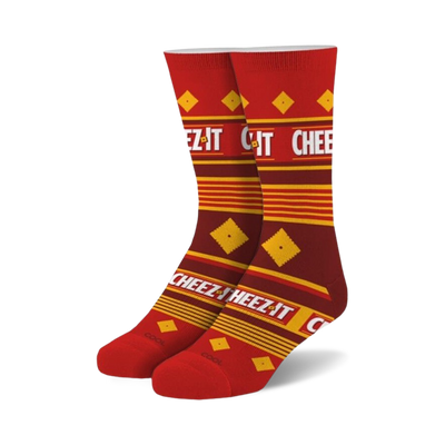Pair of crew socks in red and gold featuring a repeating Cheez-It cracker box pattern and text.