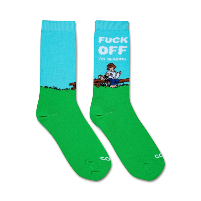 Pair of crew socks in teal and green.  Feature a graphic of a person reading on a bench with the text: 'Fuck Off I'm Reading'.