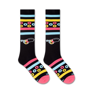 A pair of black socks with a colorful pattern of yellow and pink circles and blue and white stripes. The socks have a picture of a cartoon bird on them.
