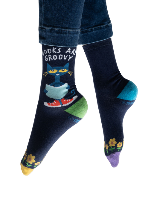 Lifestyle shot of model wearing Pete the Cat socks, showing how they look on feet with jeans.