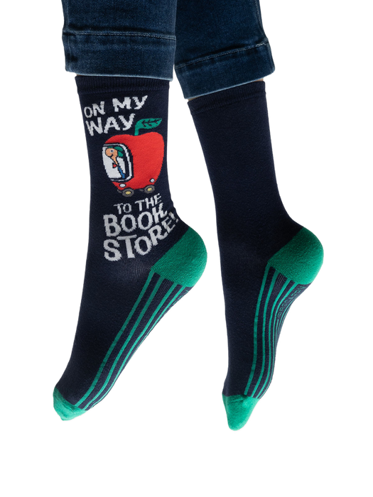 Lifestyle shot: Person wearing navy blue socks with teal stripes and a Richard Scarry apple car design.