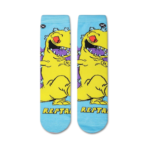 Flat lay showcasing a pair of Rugrats Reptar socks, highlighting the full design.